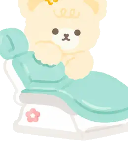 Cozy the cream-coloured bear sitting in a dental chair