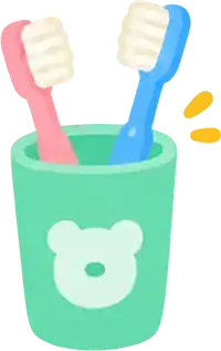 A green cup holding a pink and a blue toothbrush